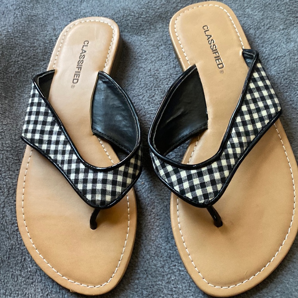 New black and odd white flip flops